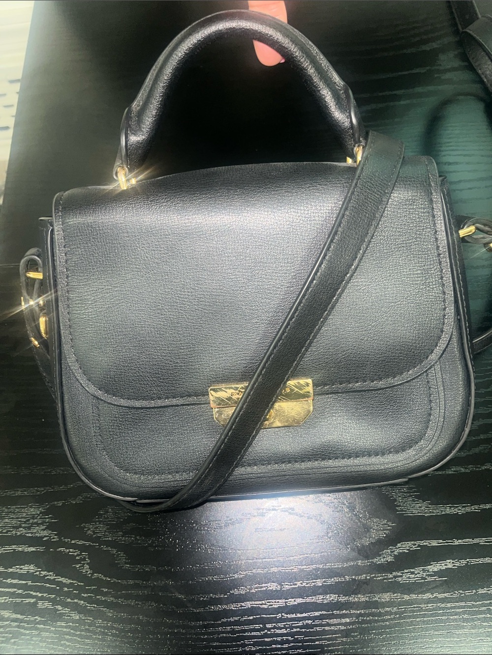 Structured Black Shoulder Bag with Top Handle and Gold Accent